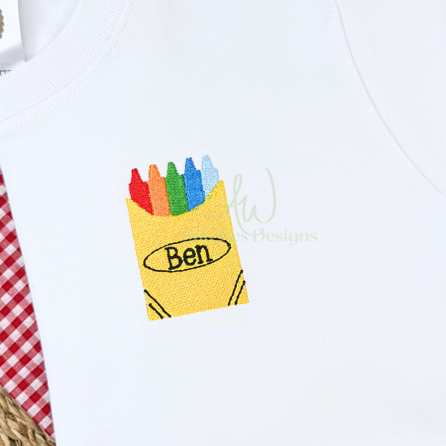 White shirt with colorful crayon design and 'Ben' text.