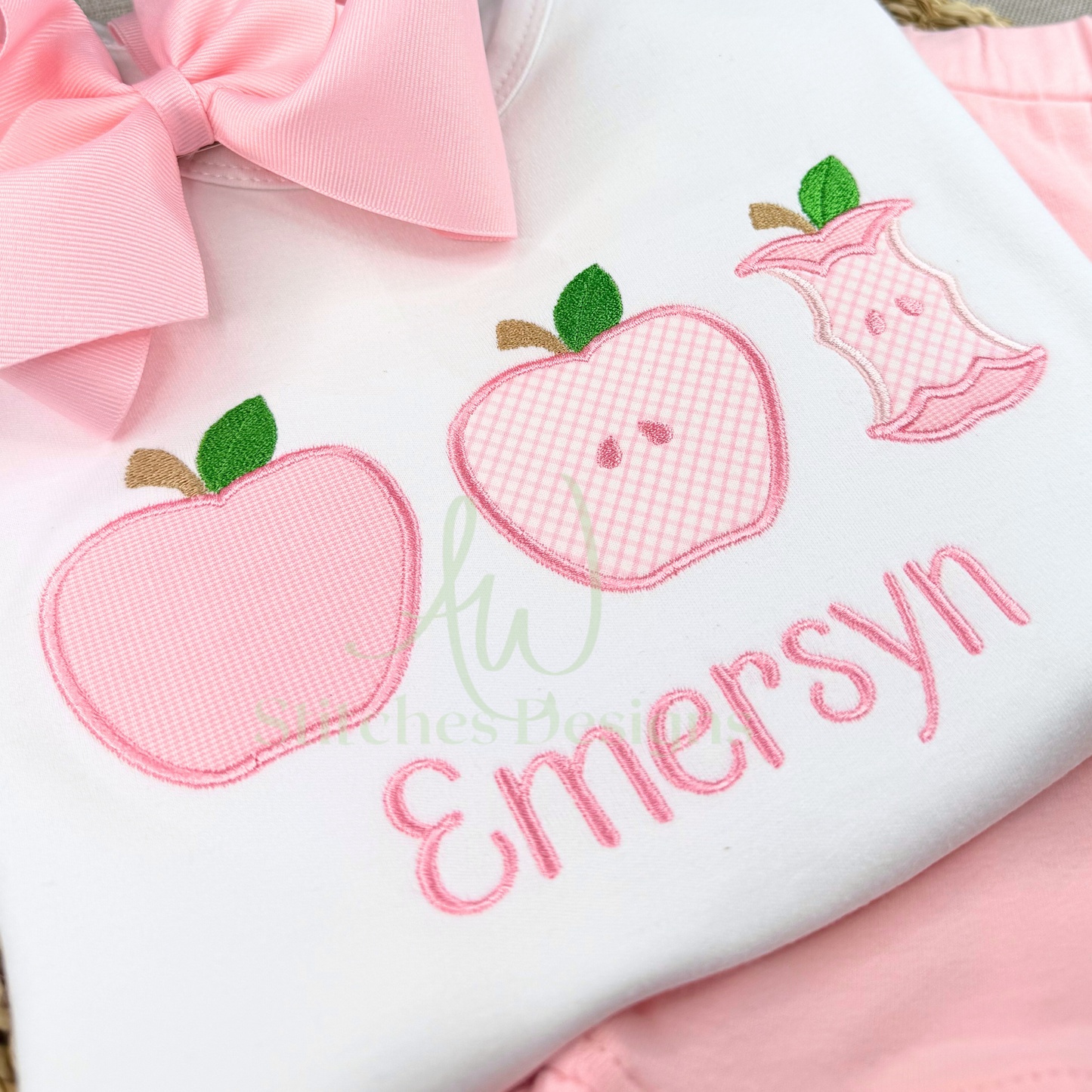 Ruffle tee with pink apples and embroidered name on a white background.