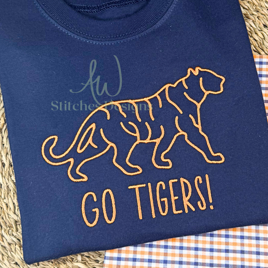 Close-up of orange satin stitch tiger embroidery on navy cotton shirt