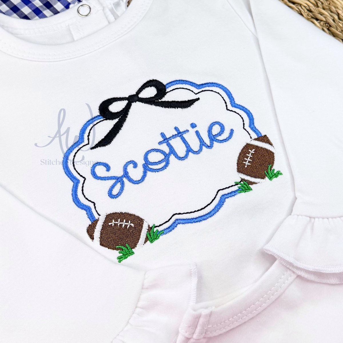 Girls football monogram frame embroidery design with scallop border, bow and football accents stitched on white shirt