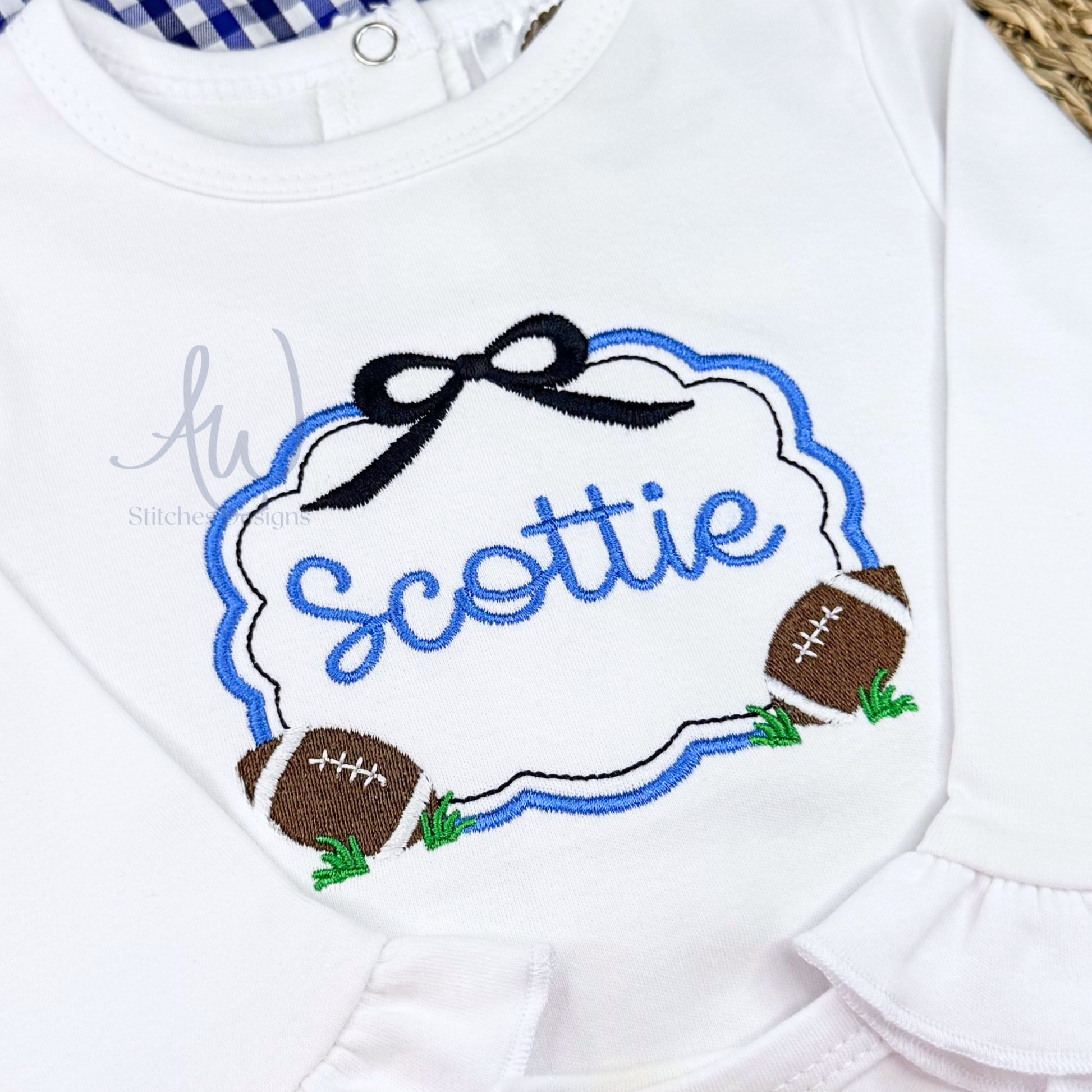 Close-up of girls football scallop frame embroidery with black bow and footballs