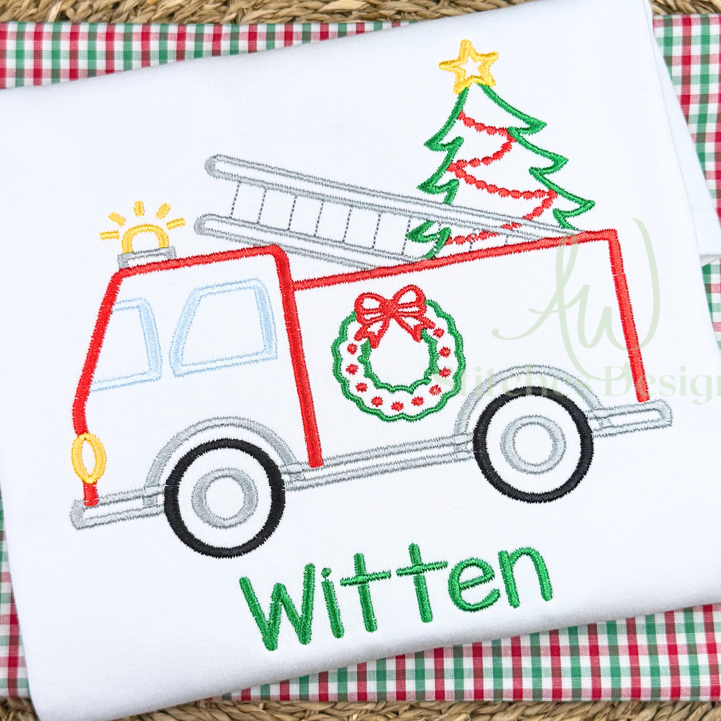 Embroidered design of a Christmas truck with tree, wreath, and 'Witten' text on a white fabric background.
