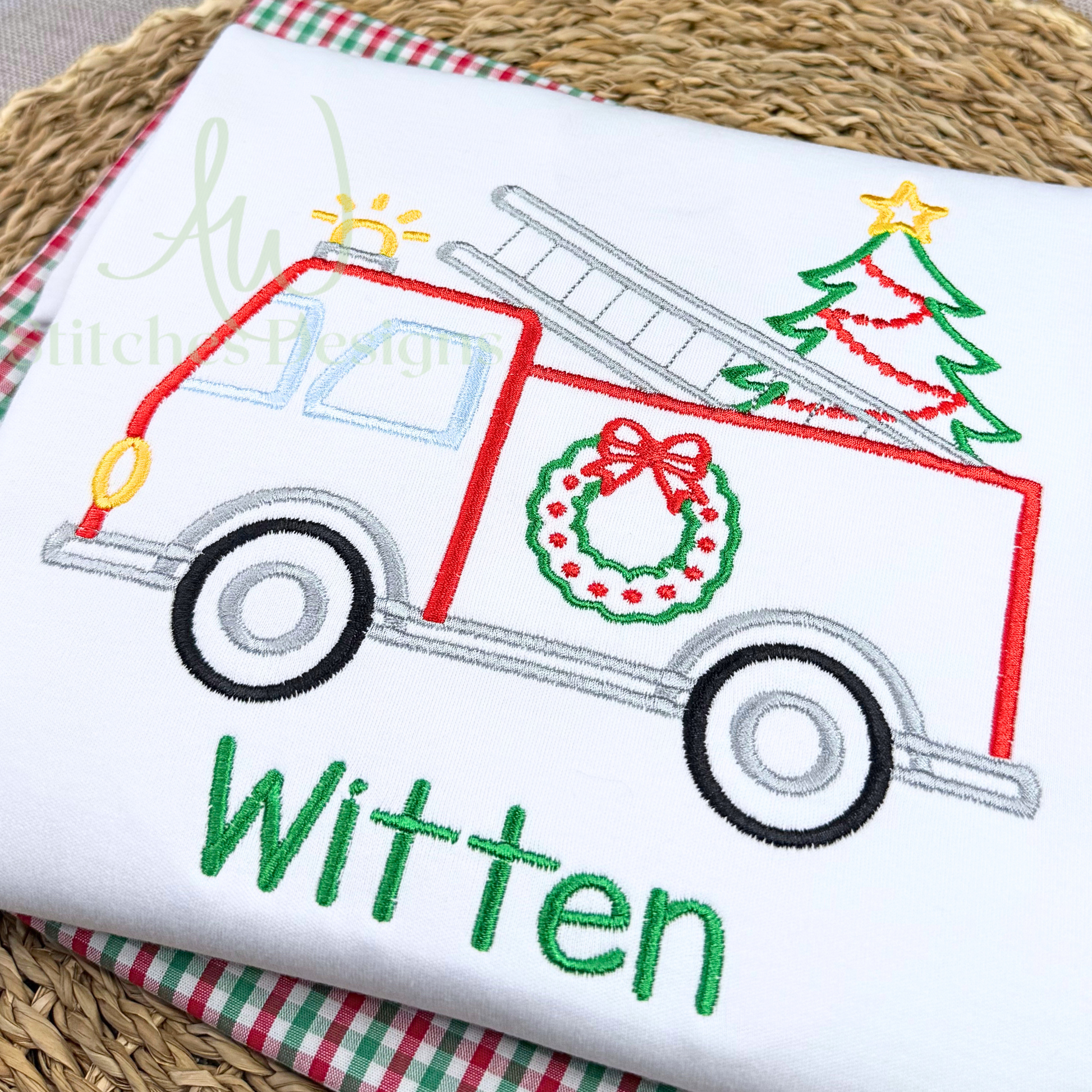 Embroidered design of a Christmas-themed truck with a tree and wreath on a white fabric background.