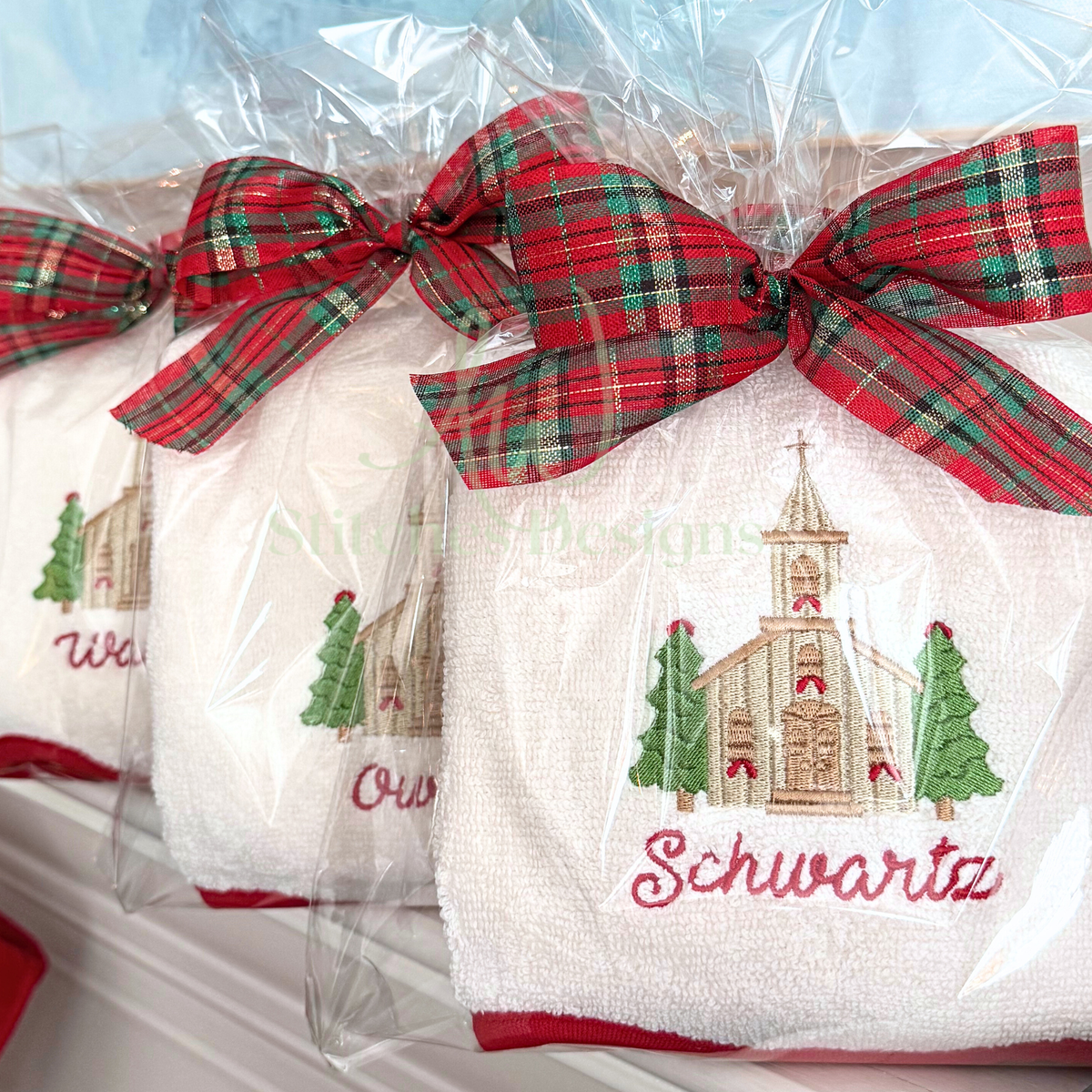 Close-up of satin stitch Christmas church embroidery with evergreen trees on white terry cloth