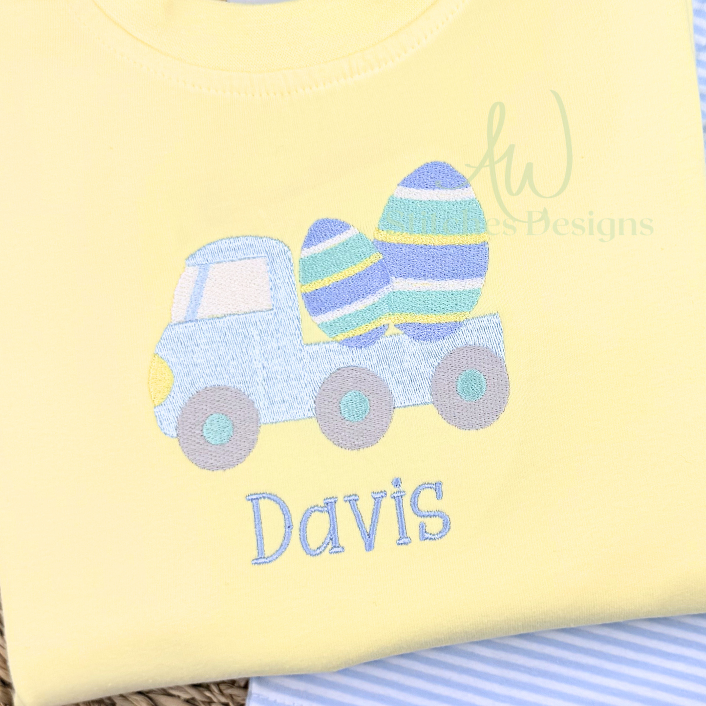 Yellow blanket with a blue truck and Easter eggs design, personalized with 'Davis'.