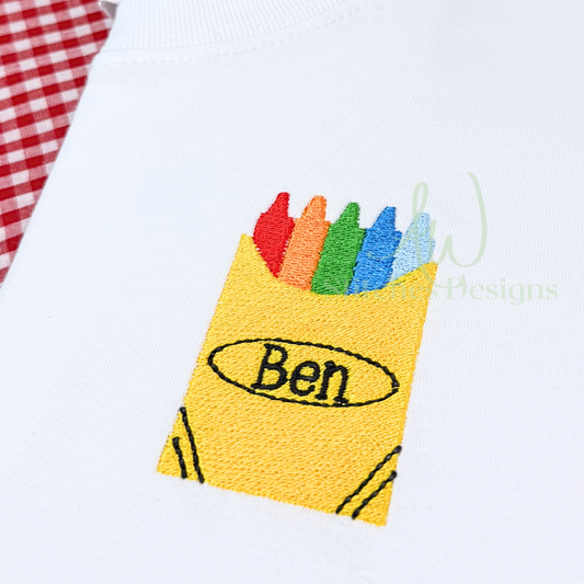 Embroidered crayon box with colorful crayons and 'Ben' on a white background
