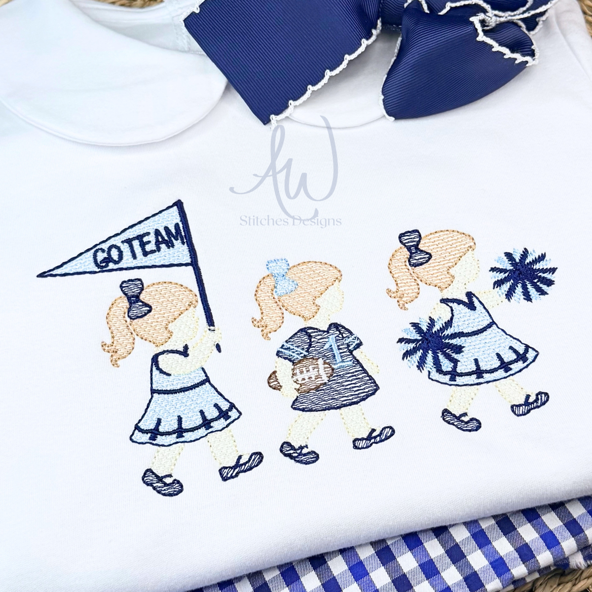 Close-up of sketch stitch cheerleader trio embroidery with football jersey and pom poms