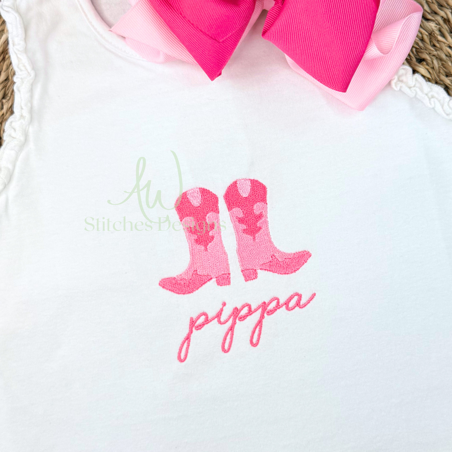 White shirt with pink rain boots and 'pippa' text on a white background